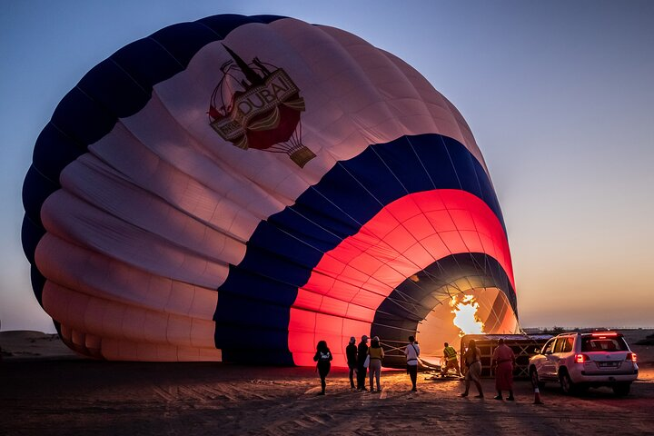 Experience the serene beauty of the Dubai desert at dawn as the hot air balloon ascends promising unforgettable views and delightful moments. Immerse in adventure with falcons and a gourmet breakfast.